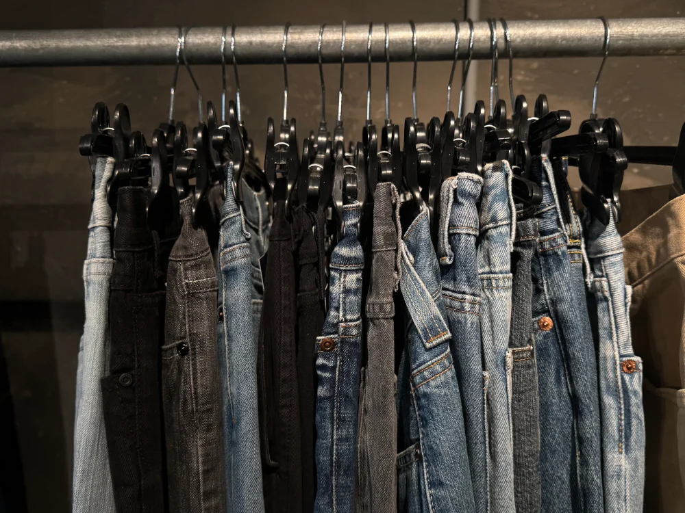 rack of jeans in a thrift store